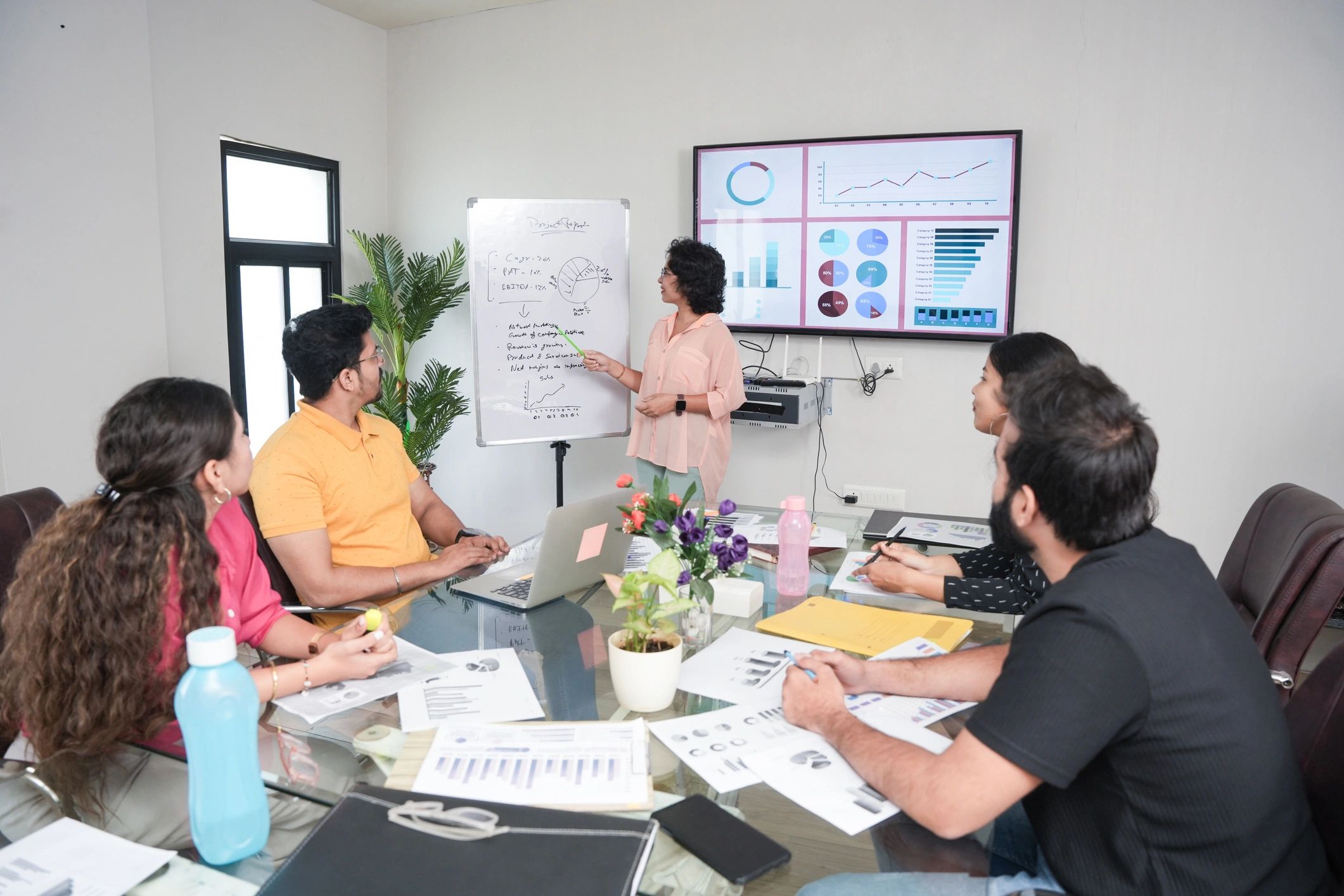 Business team reviewing procurement plans in a boardroom